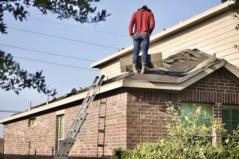 Professional roofer working on a residential roof in Central Davis